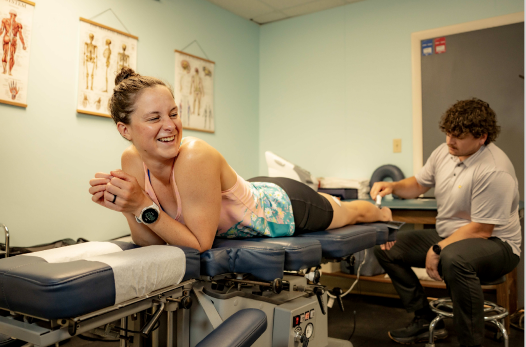 Professional IRONMAN athlete Alice Alberts receiving Achilles tendinopathy treatment at Mui Chiropractic & Sports Medicine in Newton, MA.